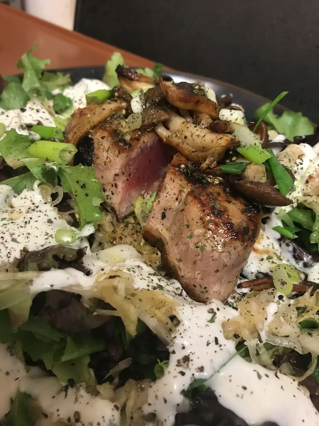 Seared steak with mushrooms, greens, and composed accompaniments