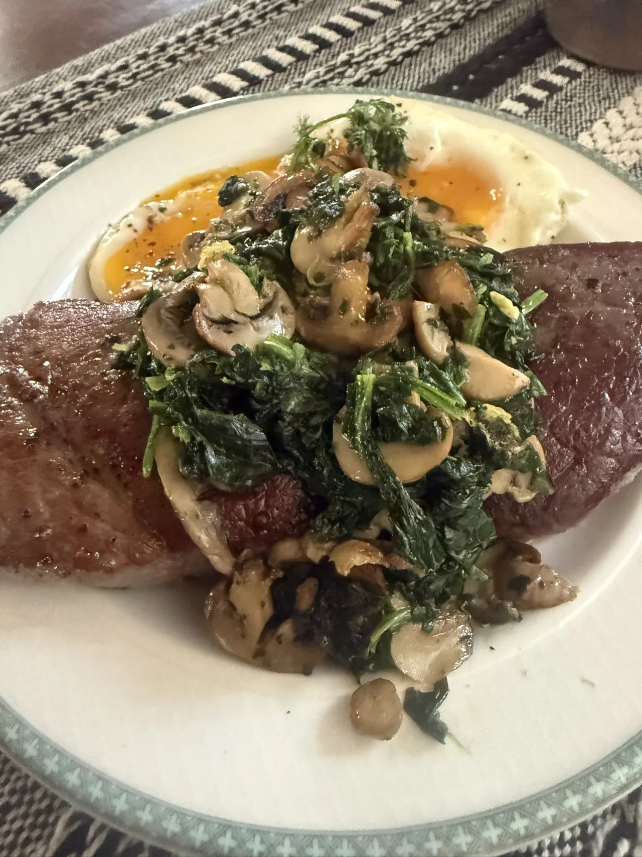 Steak and eggs with mushrooms and greens